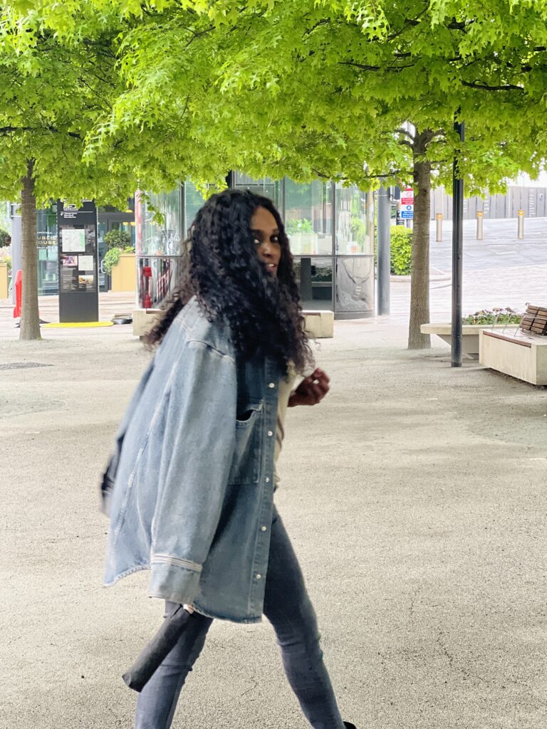 Woman Draping denim jacket on shoulder