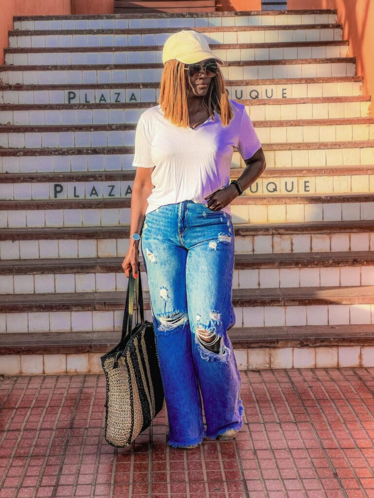 A stylish woma rocks classic blue jeans and white tshirt.
