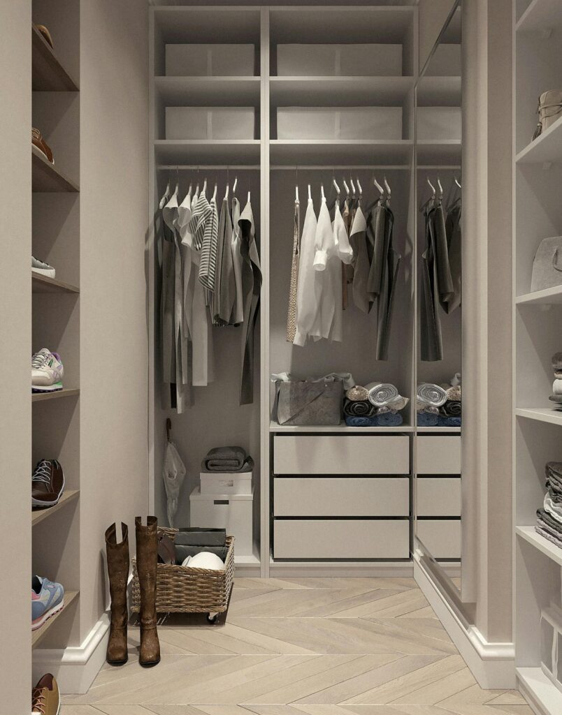 Clothes and shoes — neatly arranged and colour-coordinated — to maximise storage space and maintain a clutter-free aesthetic in a modern walk-in wardrobe.