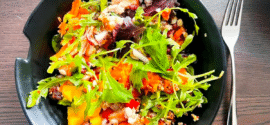 Bowl of green mixed salad made from leftovers.