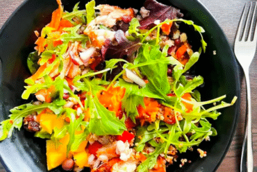 Bowl of green mixed salad made from leftovers.