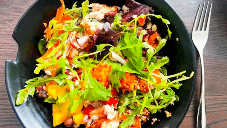 Bowl of green mixed salad made from leftovers.