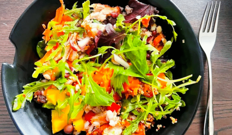 Bowl of green mixed salad made from leftovers.