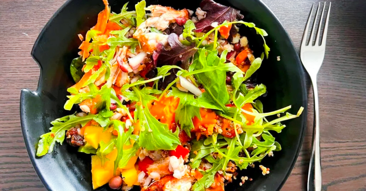 Bowl of green mixed salad made from leftovers.