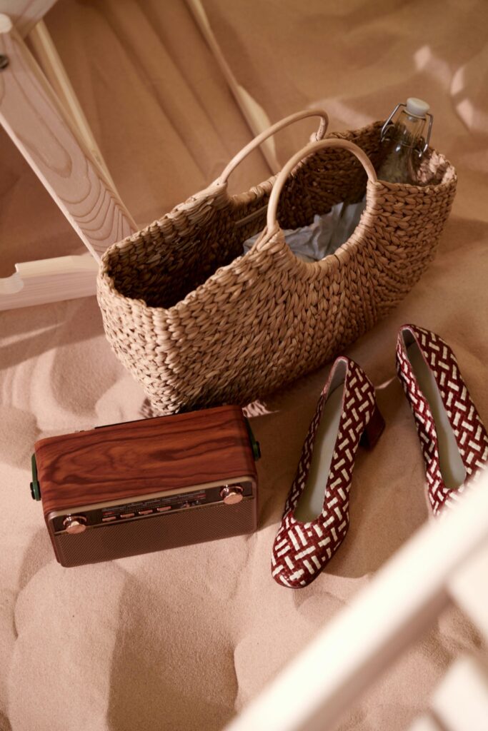 A brown summer straw bag that is a fashionable accessory for warm weather outings and beach vacations holidays.
