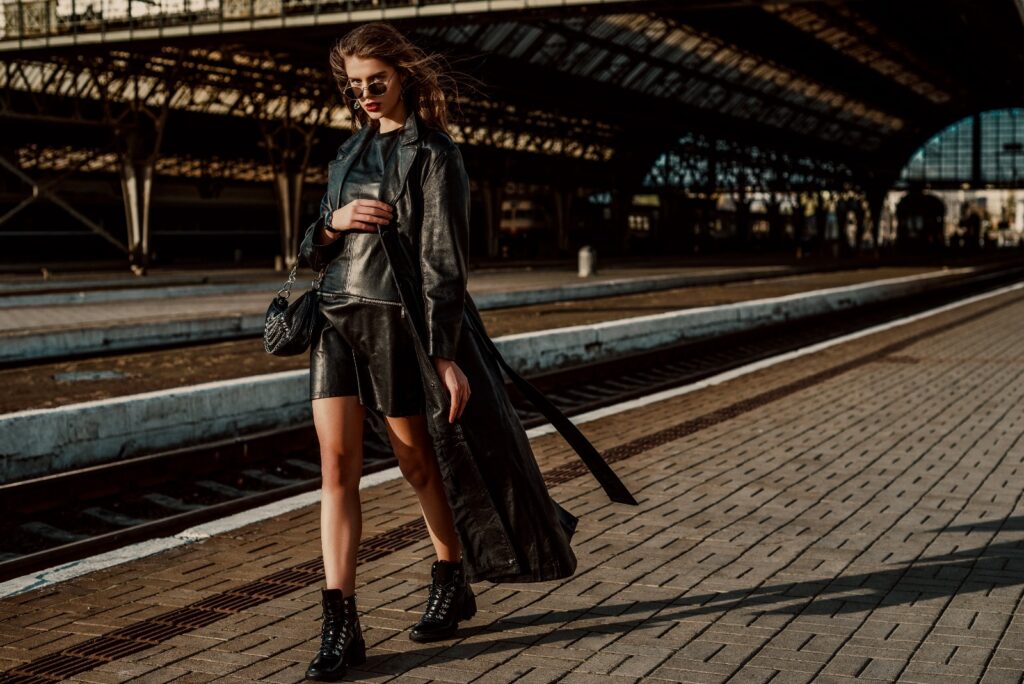 Woman in an all black outfit at a train station