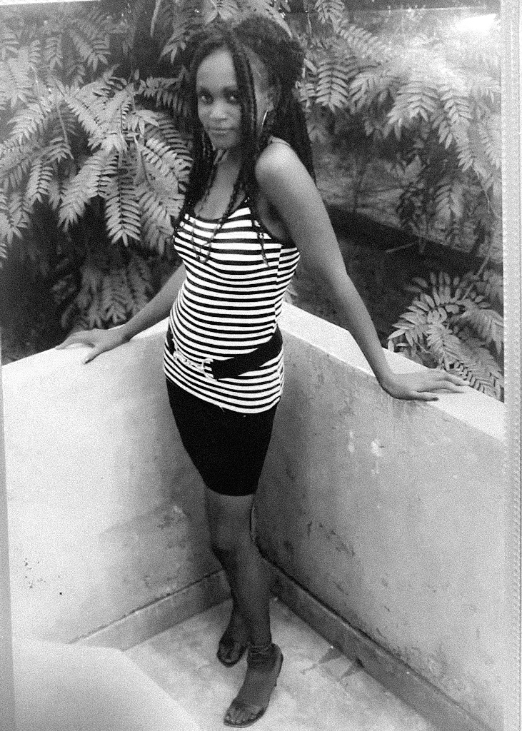  A young woman in a striped top and belted skirt showcasing Y2K fashion -—a perfect example of 2024 fall outfit trends that are making a comeback. 