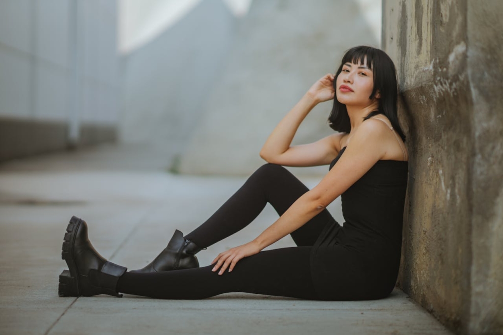 woman in all black outfit wearing black  block ankle boots 