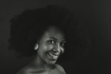 Black and white potrait photo of a black woman with a healthy Afro