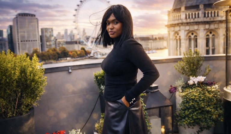 Word of the year growth — a reflective portrait of Nillah on a London rooftop at sunset, symbolising intention and personal growth.