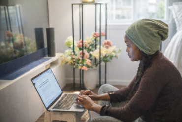 Woman working on a laptop at home, reflecting on a career change at 40