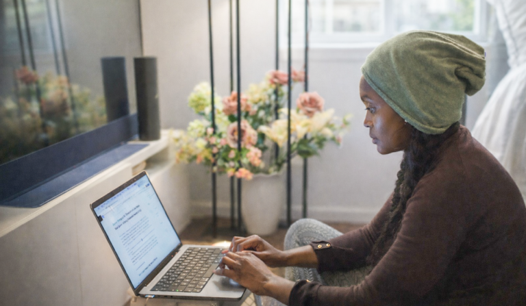 Woman working on a laptop at home, reflecting on a career change at 40