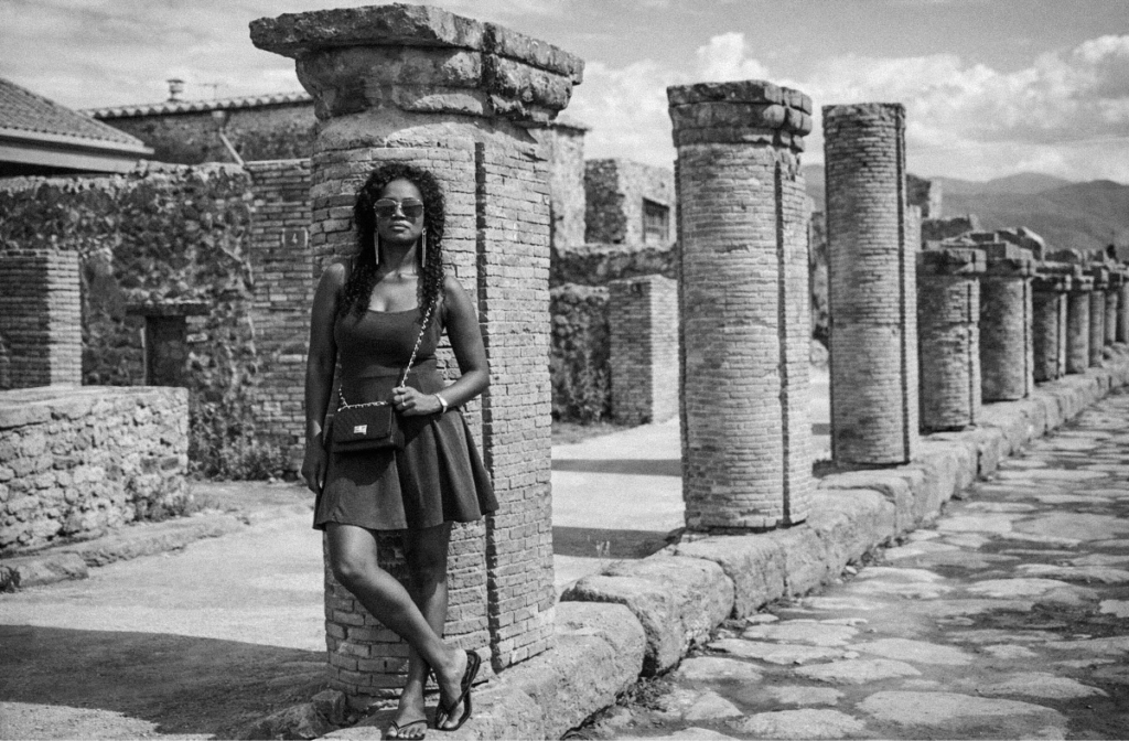 Woman standing among the ancient ruins of Pompeii in Italy